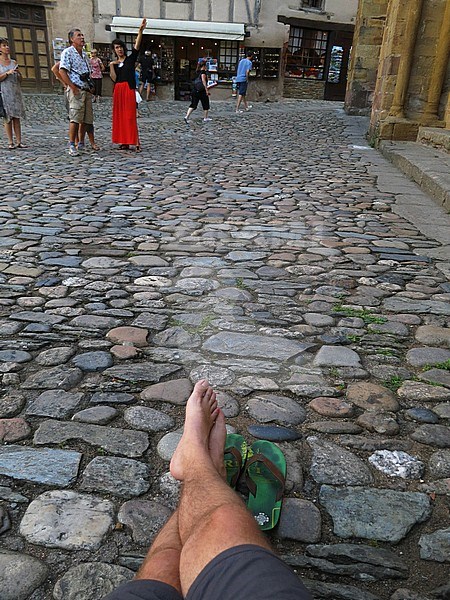 Resting pilgrom in historic town center of Conques during the day, along the Via Podiensis n southern France. Next to Abbey-Church of Saint-Foy. stock-image by Agami/Marc Guyt,